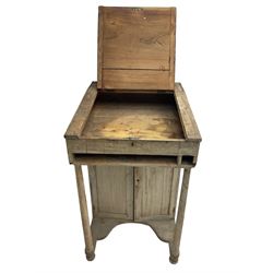 19th century clerk's desk, the hinged top supported by two turned uprights, fitted with cupboard enclosed by to panelled doors, on turned feet, the back painted with 'Reception' 