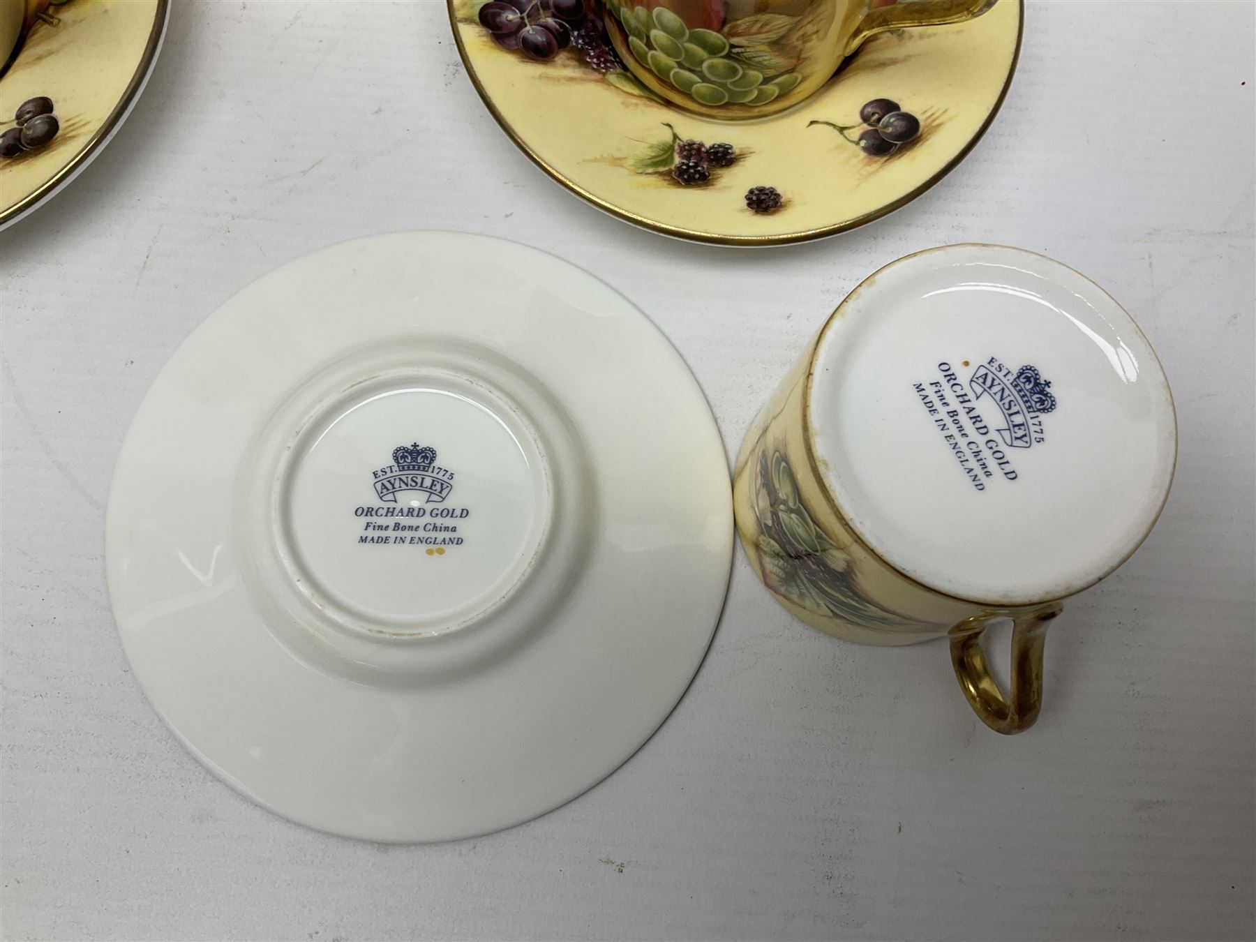 Aynsley Orchard Gold five coffee cans and saucers, mantel clock, plate etc 