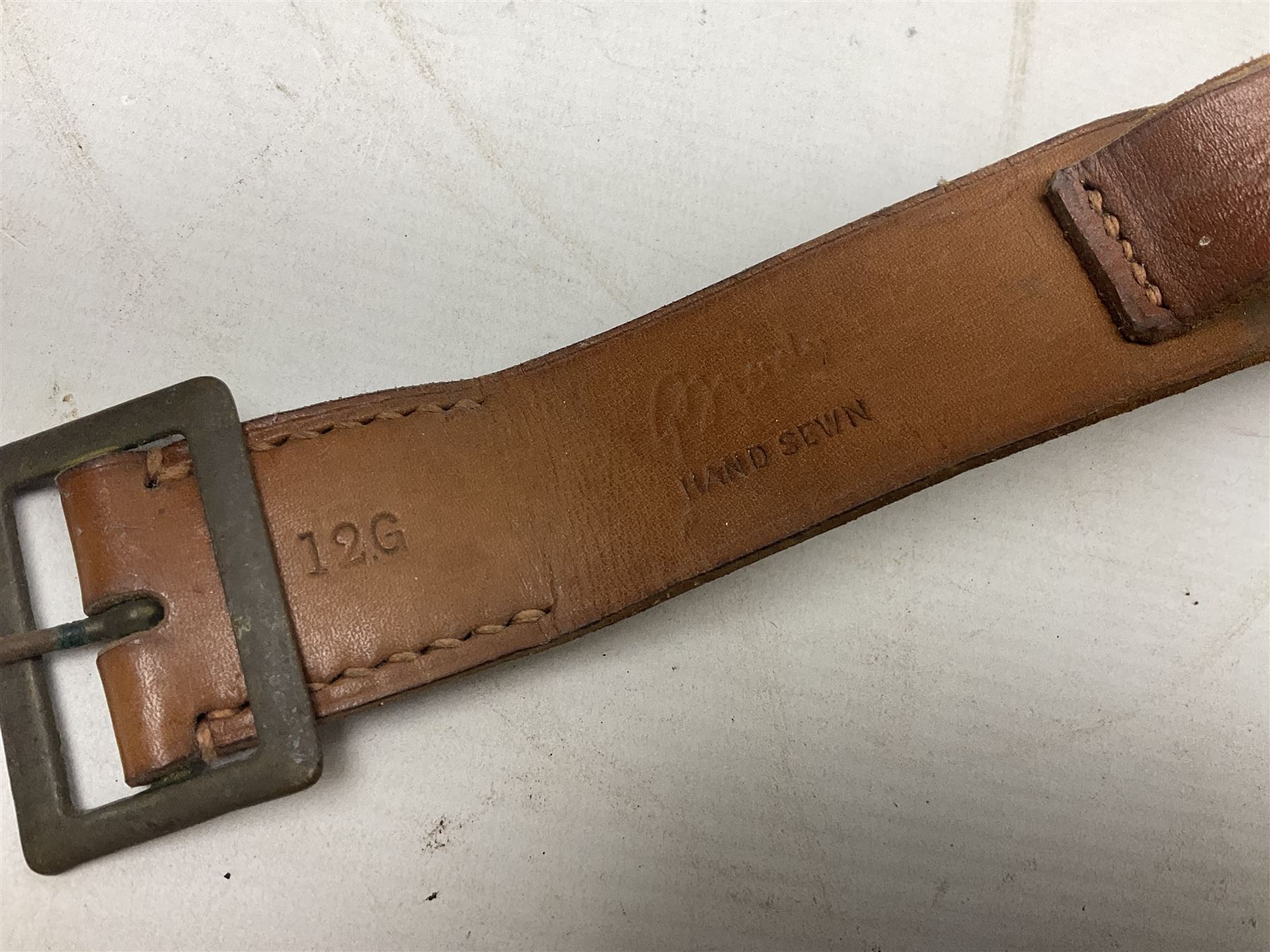 Mundial Brazil bowie knife, the 15.5cm steel blade inscribed 'Sheriff Knife', with banded and aluminium hilt; in leather sheath L29cm overall; British Army felt covered metal water bottle with webbing strap; leather 12-bore cartridge belt; and small pair of non-military binoculars in part case (4)