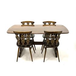 Ercol Beamish refectory rectangular dining table, two shaped supports with sledge feet, joined by moulded stretcher (L153cm, D76cm, H71cm) and four Windsor chairs featuring shaped splat and turned supports (W42cm)