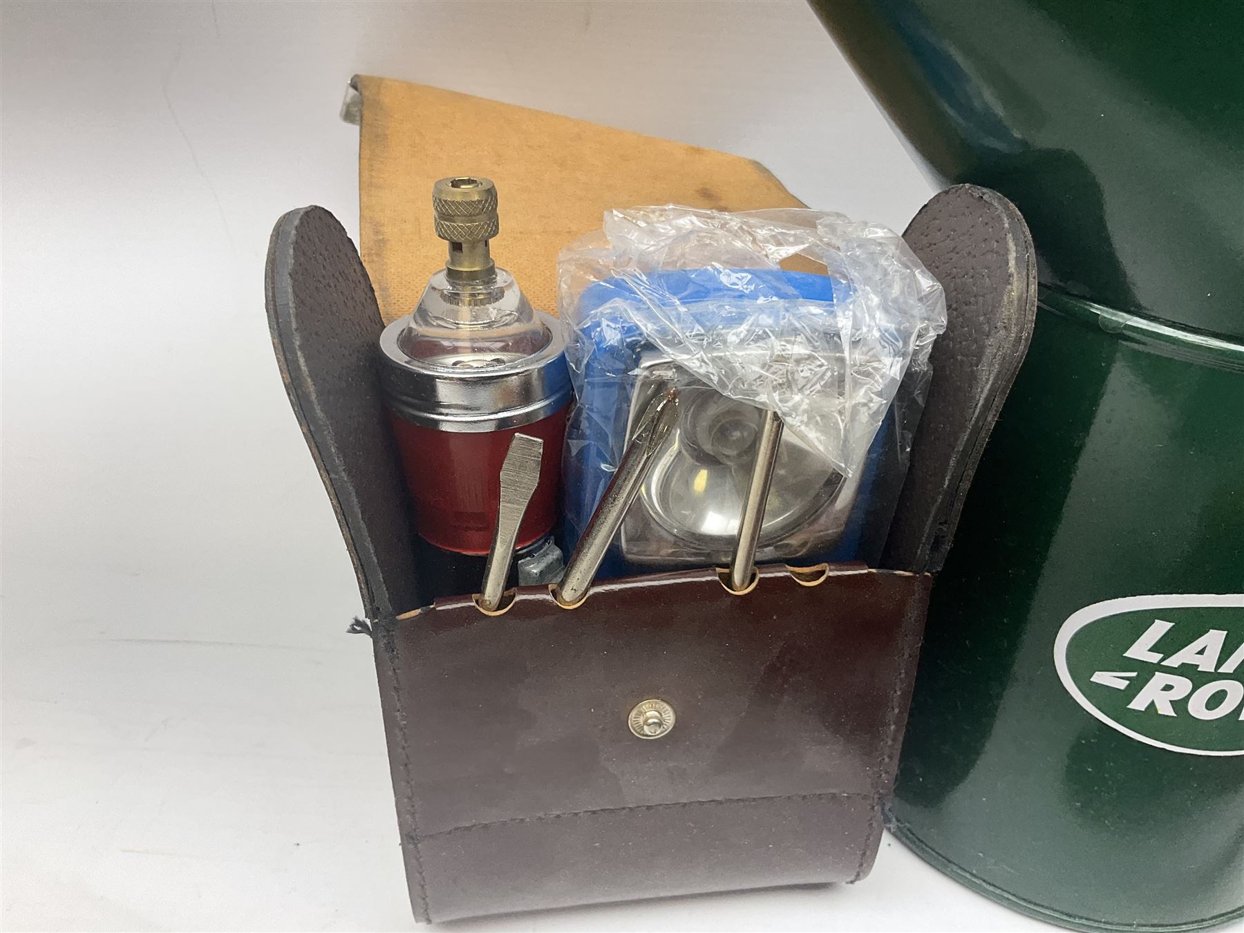 Bugatti cast iron sign with a red background, Shell Oil cast iron sign with gold background, together with Land Rover oil can, motorist warning lamp & torch tool kit and other motoring items 