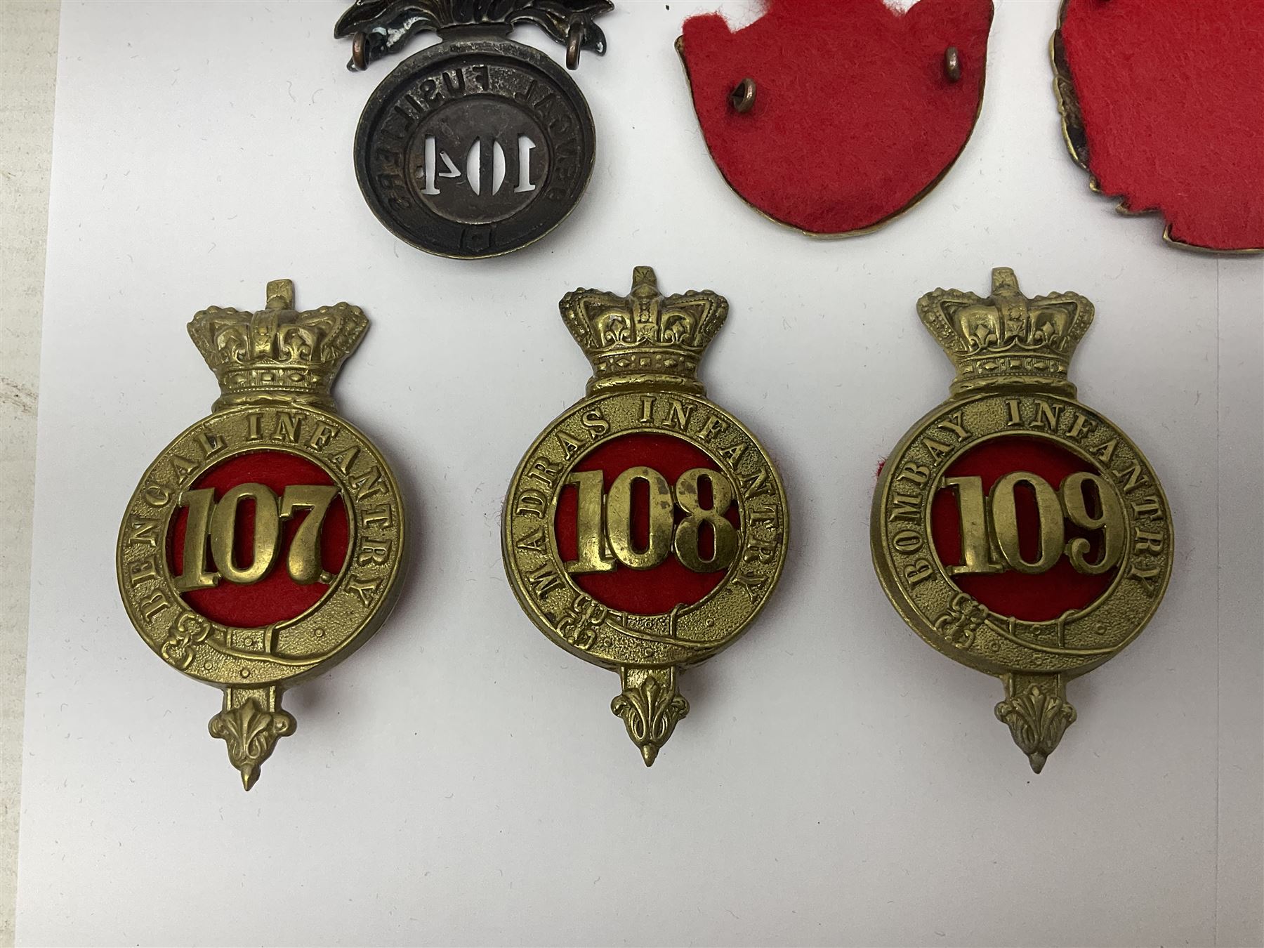 Ten cap badges of Indian interest comprising Bengal Fusiliers No.104, Bengal Infantry No.107, Royal Bengal Fusiliers No.101, Bombay Infantry No.109, Bombay L.I. No.106, two Royal Madras Fusiliers No.102, Madras Infantry No.108 and Madras L.I. No.105 (10)