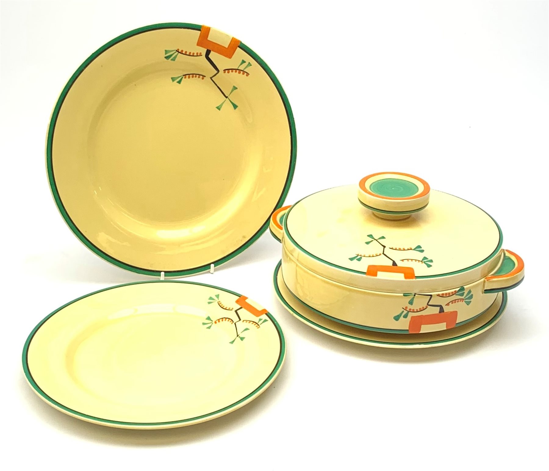 A Clarice Cliff Bizarre by Wilkinson/Newport Pottery vegetable tureen and cover, dinner plate and two dessert plates in the Ravel pattern. (4).