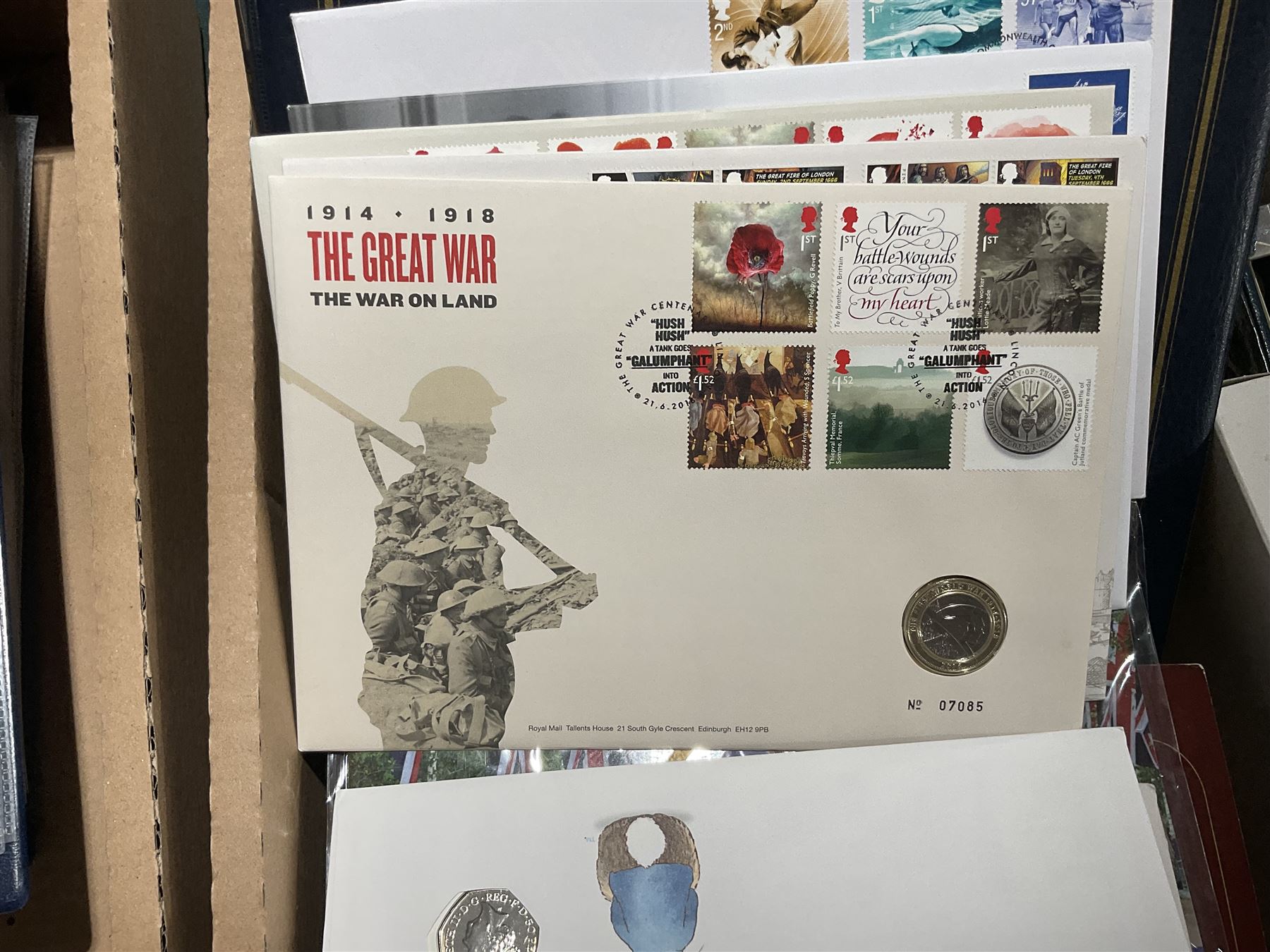 Approximately one hundred and fifteen Royal Mint coin covers, in two ring binder folders and loose, together with approximately 53 grams of Great British pre-1920 and approximately 68 grams of Great British pre-1947 silver threepence coins, and a small quantity of further pre-decimal coins