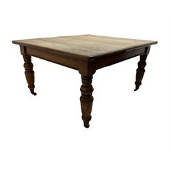 Late Victorian oak dining table, moulded rectangular top, four turned supports with brass and ceramic castors 
