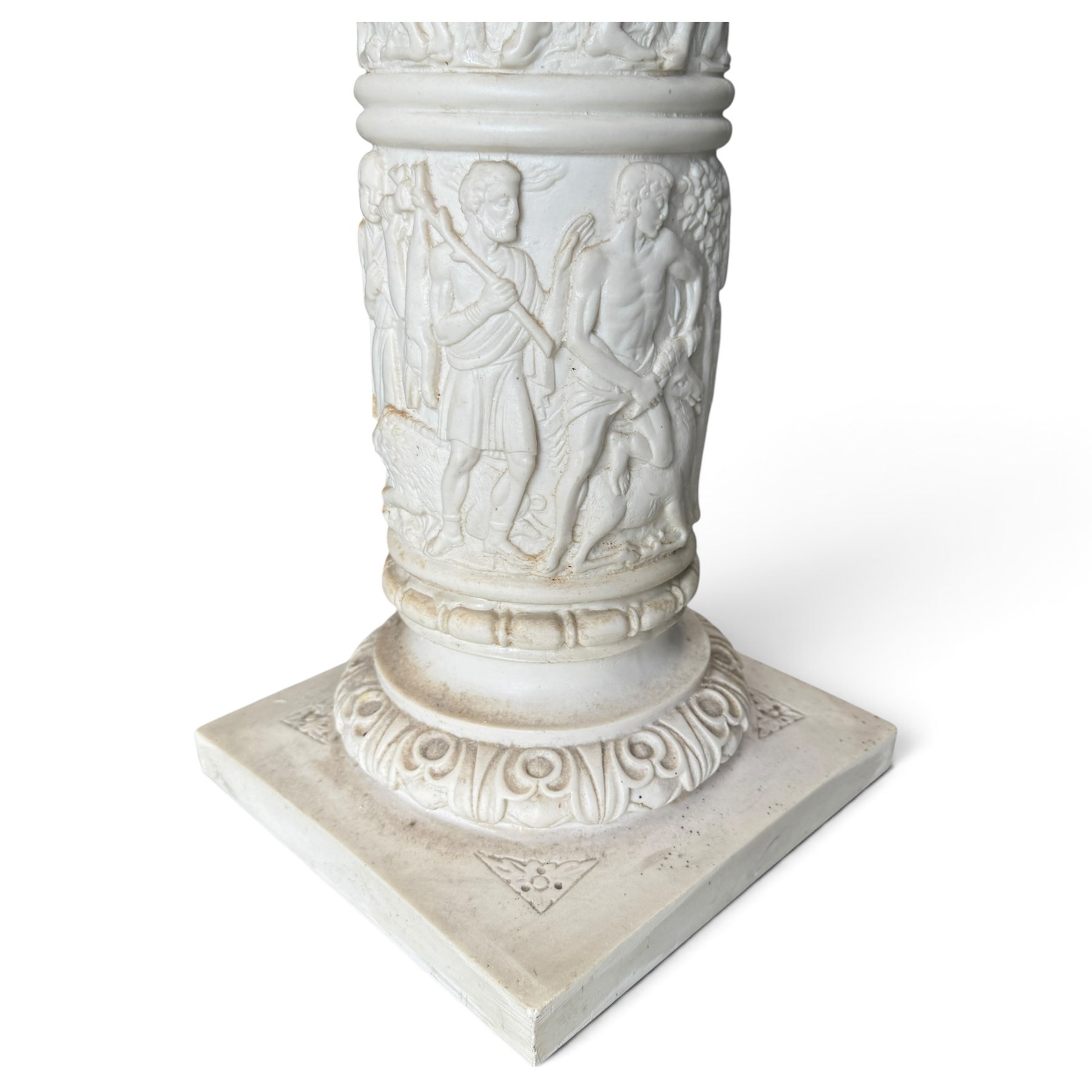 Neoclassical design composite column, square top over composite Ionic and Corinthian capital, the pedestal decorated with hunting and religious procession scenes, waisted and foliate socle on square base