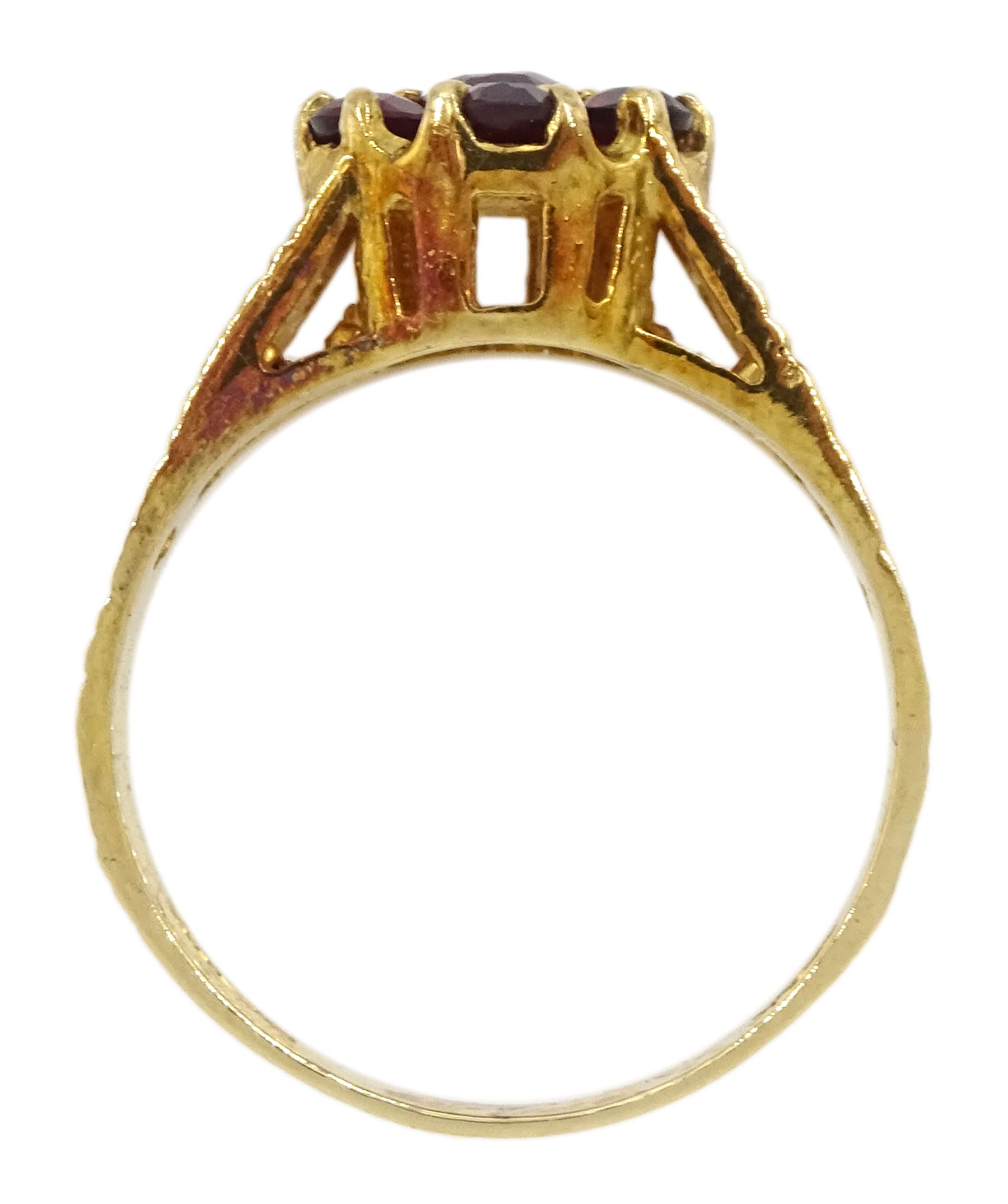 9ct gold garnet flower head cluster ring, with textured and pierced shoulders by Slade & Kempton, London 1978