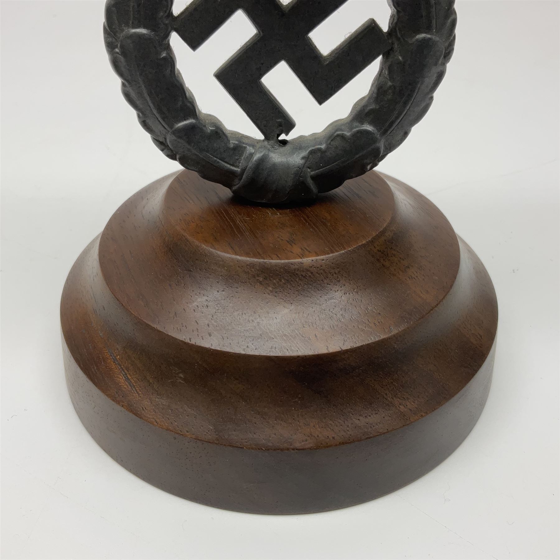 WW2 German cast white metal desk ornament/paperweight as the eagle insignia on later turned mahogany plinth H22cm