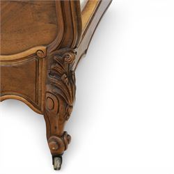 Early 20th century French walnut single bedstead, the shaped and moulded headboard with carved foliate crest above a panelled field, with conforming serpentine footboard with moulded reserves, the shaped apron with applied carved detail, raised upon cabriole supports with carved knees