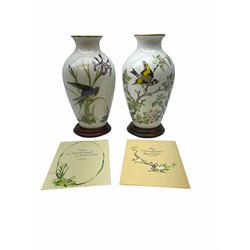 Pair of Franklin Porcelain ovoid vases, The Meadowland Bird Vase and The Woodland Bird Vase by Basile Ede H30cm, with wooden stands and certificates.