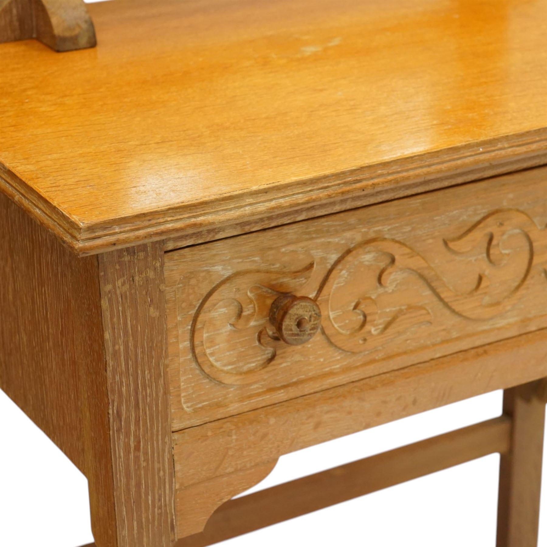Arts & Crafts design limed oak bedroom suite; comprising dressing table, single wardrobe and chest, with carved scrolling motifs.

Wardrobe (H 181cm, D 47cm, W 79cm)
Chest (H 74cm, D 46cm, W 73cm)
Dressing table (H 136cm, D 47cm, W 74cm)