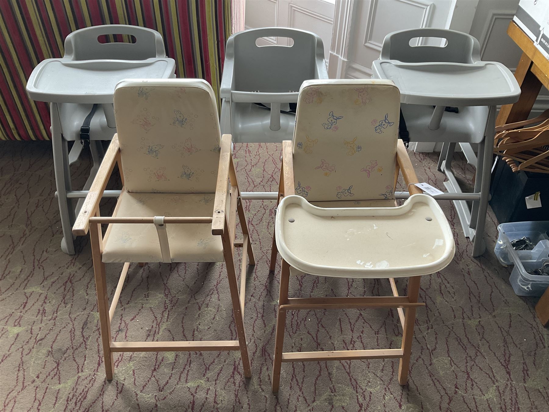 Set of three plastic and a pair of wooden baby high chairs with additional saddle stools (9)- LOT SUBJECT TO VAT ON THE HAMMER PRICE - To be collected by appointment from The Ambassador Hotel, 36-38 Esplanade, Scarborough YO11 2AY. ALL GOODS MUST BE REMOVED BY WEDNESDAY 15TH JUNE.