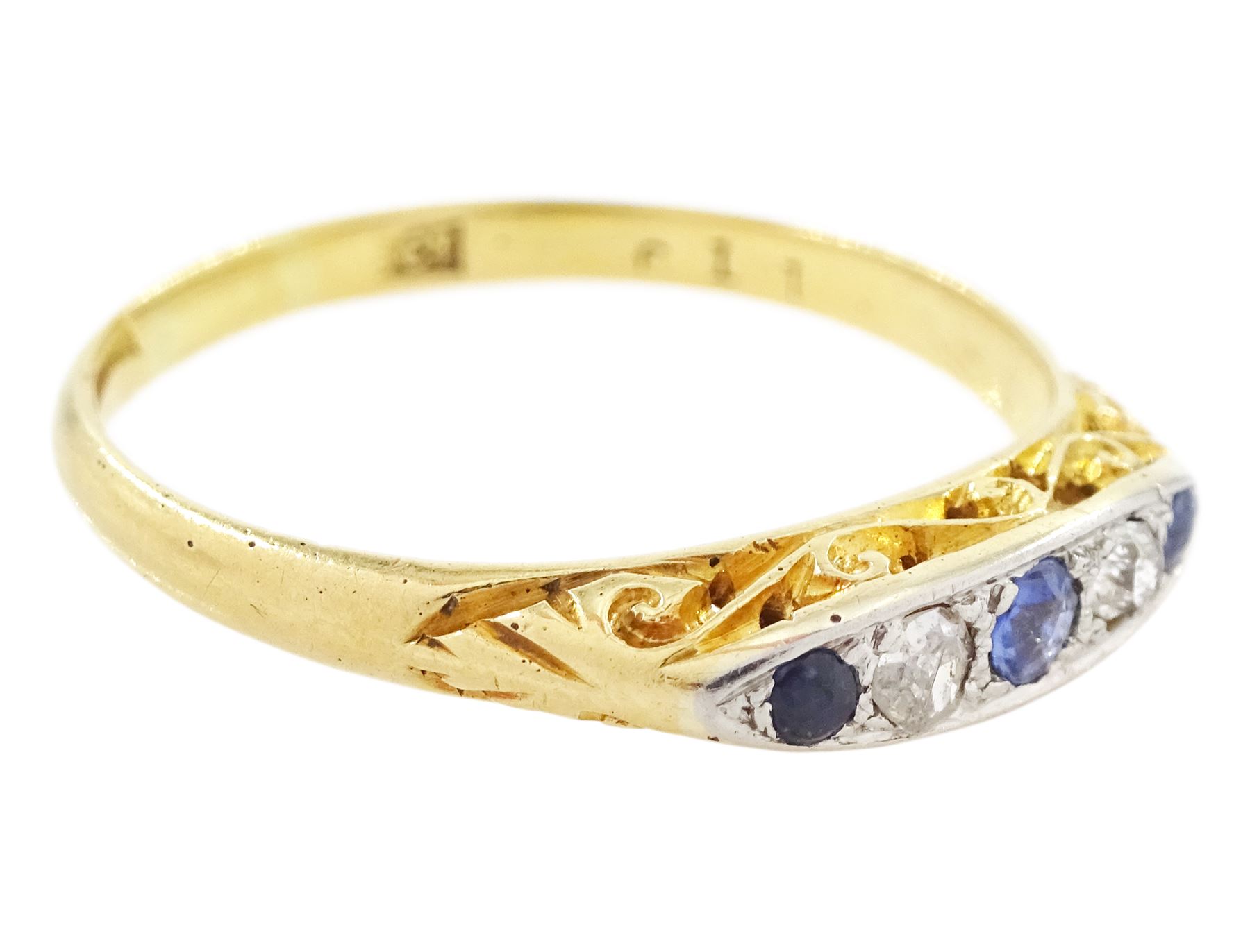 Early 20th century 18ct gold sapphire and diamond five stone ring, set with three round cut sapphires and two old cut diamonds and scroll engraved gallery 