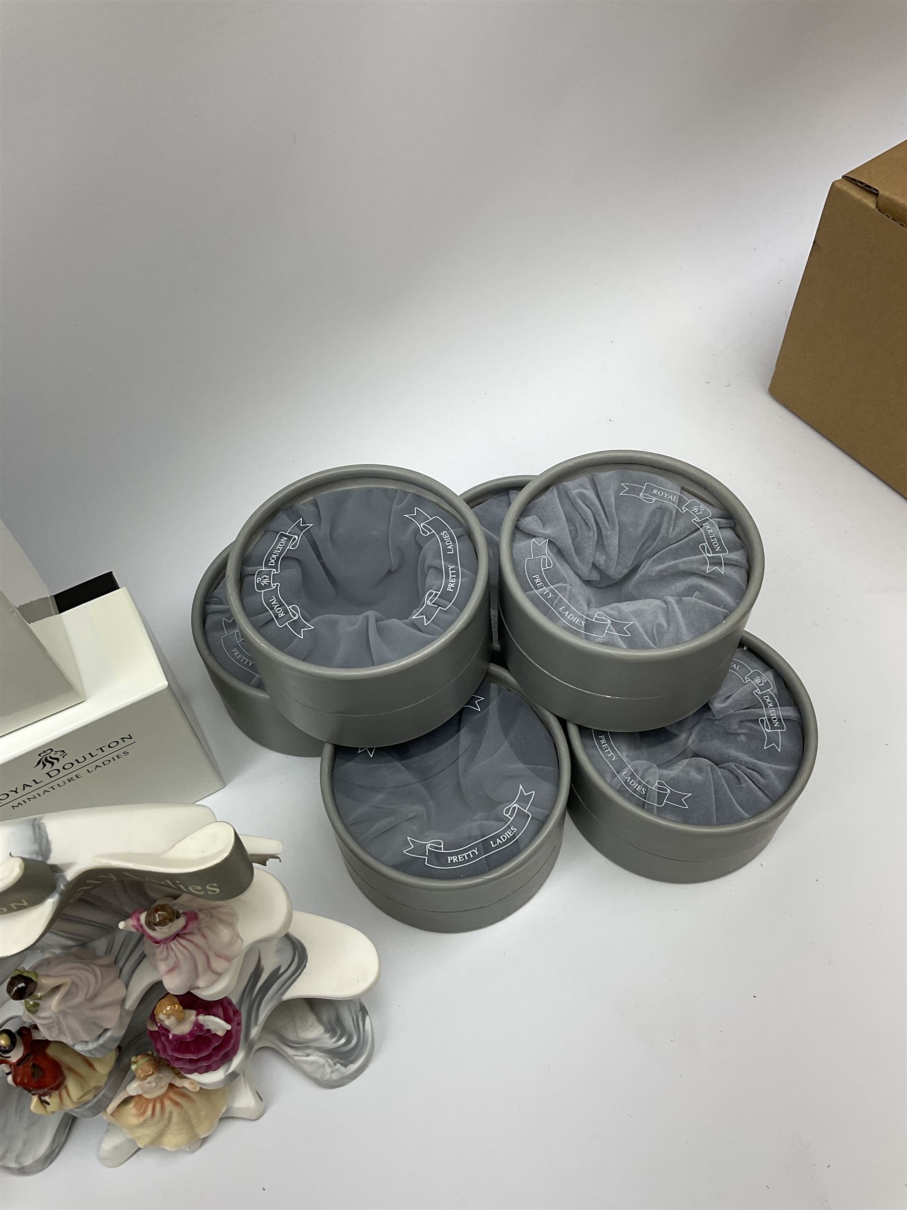 Six Royal Doulton Pretty Ladies figures, comprising Rebecca, Belle, Deborah, Jennifer, Jessica, and Lauren, with display stand, together with ten Royal Daulton Miniature Ladies figures, Ninette, Christine, Rachel, Elizabeth, Margret, Karen, Elaine, Victoria, Jane, and Susan, with display stand, all with boxes. 