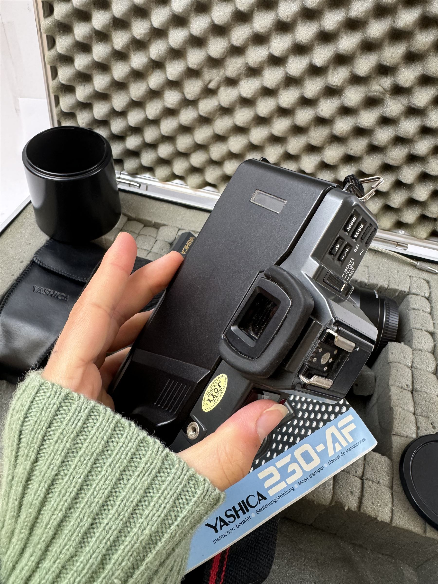 Yashica 230-AF camera outfit, including camera body serial no. 0184693, three Yashica lenses comprising AF 70-200mm 1:4.5 serial no. F6162003, AF 28-85mm 1:3.5-4.5 macro lens serial no. F6225564 and an AF 75-300mm 1:4-5.6 Macro lens serial no. F7100913, flash, hood and other accessories and instruction booklet, contained within a silver flight case 