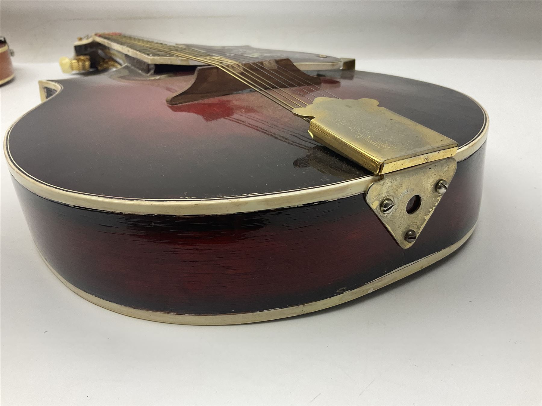 Eastern eight-string mandolin with sunburst finish and mother-of-pearl inlay L68.5cm; and another Harmony mandolin with cracked headstock (2)