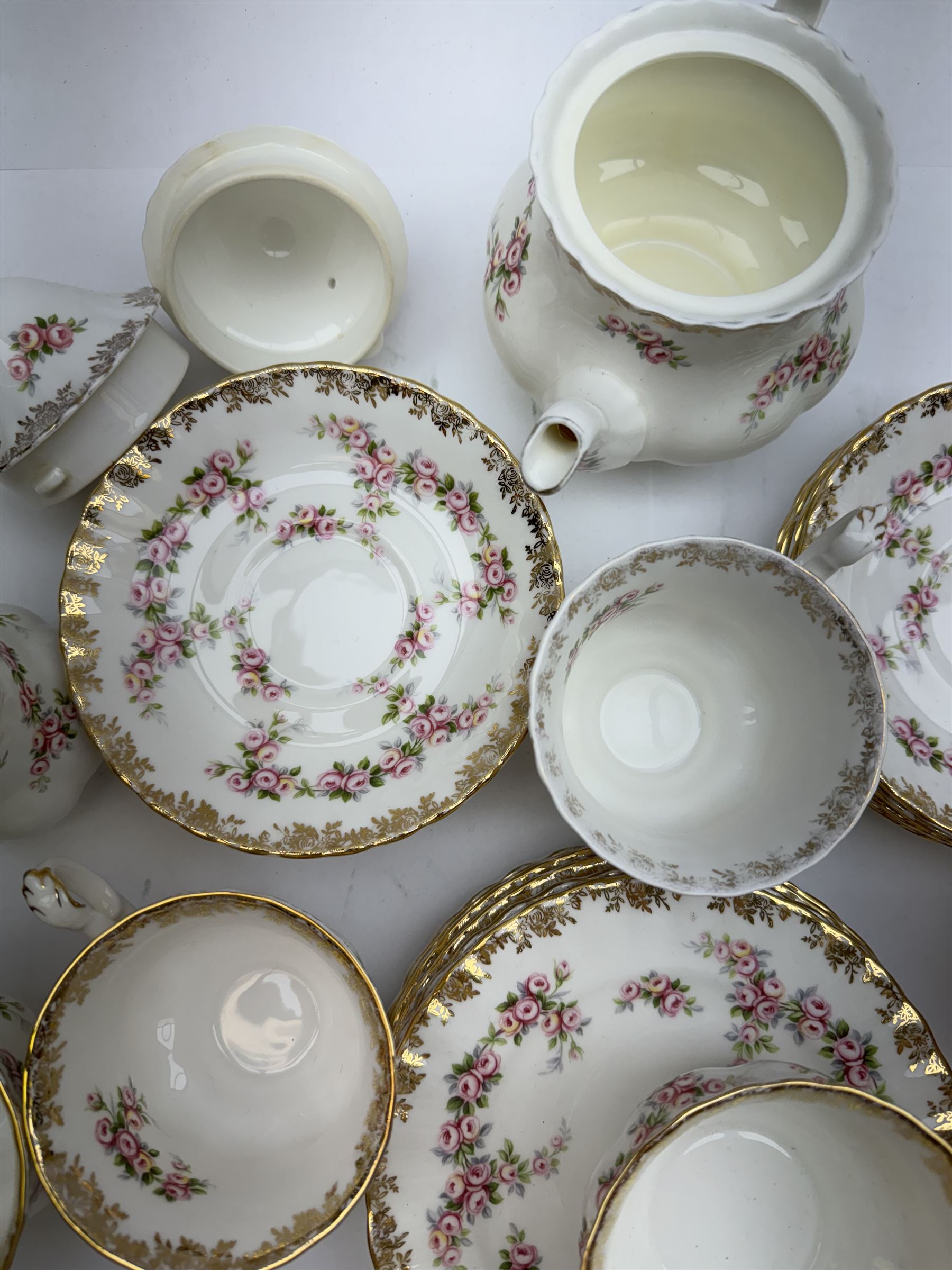 Royal Albert Dimity Rose pattern tea service for six place settings, including teapot, teacups and saucers, sugar bowl and two milk jugs, all with printed mark beneath