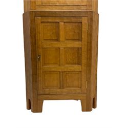 'Acornman' adzed oak corner cabinet, the top section enclosed by astragal glazed door, the lower section enclosed by panelled door, all over adzing, by Alan Grainger of Brandsby 