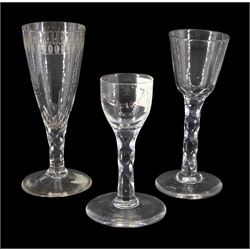 Three late 18th/early 19th century drinking glasses, with funnel and rounded funnel bowls, one example with engraved band, another with stylised cut swag, upon diamond faceted stems and conical feet, tallest H15.5cm