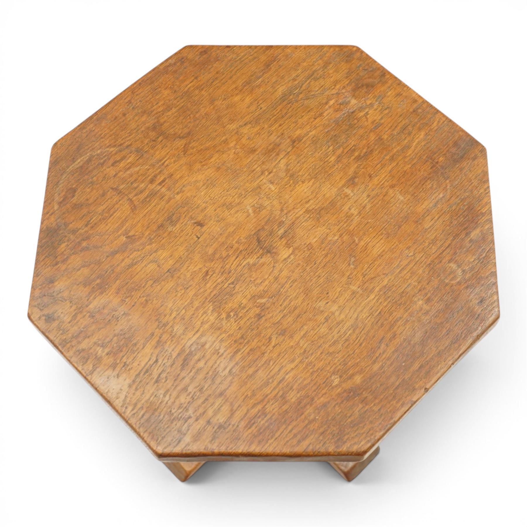 Mouseman - mid-20th century adzed oak coffee table of small proportions, the octagonal  adzed top raised on cruciform base and sledge feet, carved with mouse signature, by the workshop of Robert Thompson of Kilburn 