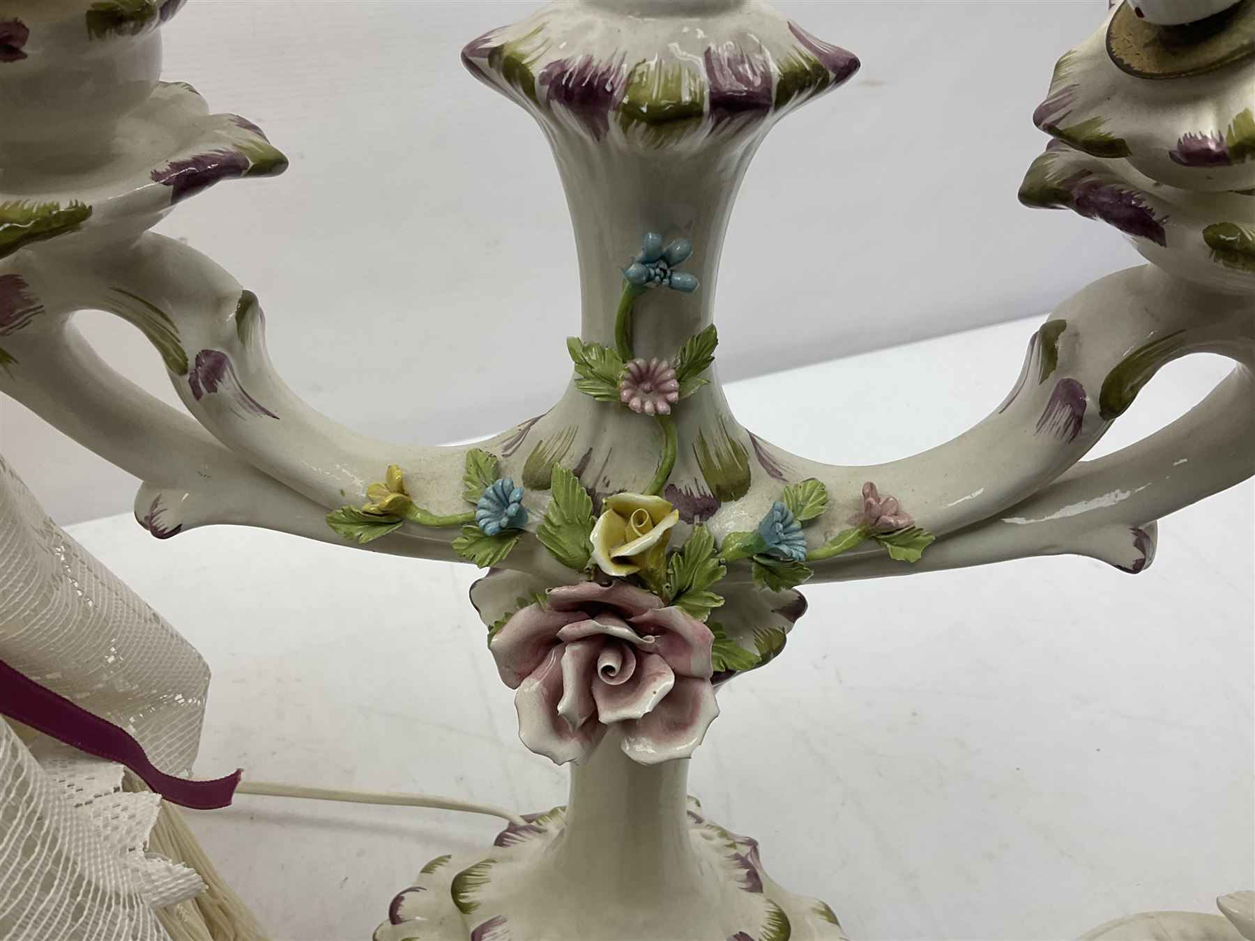 Jaffe Rose figural ceramic table lamp, modelled as two putti climbing a column with gilded cloth, together with a Capodimonte floral two light table lamp and a collection of lamp shades