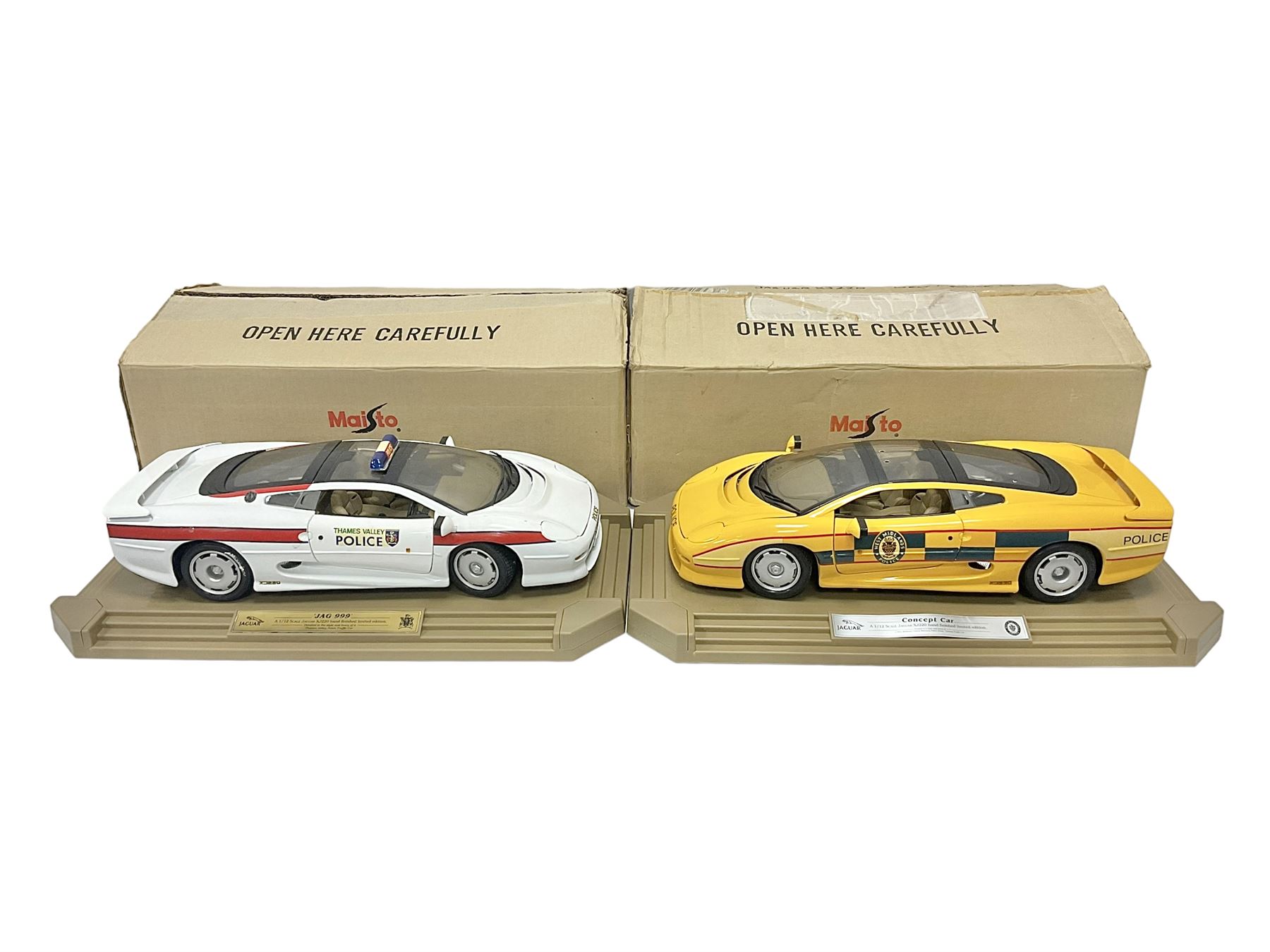 Two Maisto 1:12 scale Jaguar XJ220 scale cars comprising 1992 ‘Concept Car’ West Midlands Police car and 1994 ‘Jag 999’ Thames Valley Police Traffic Car, both on plinths with original boxes and certificates of authenticity 