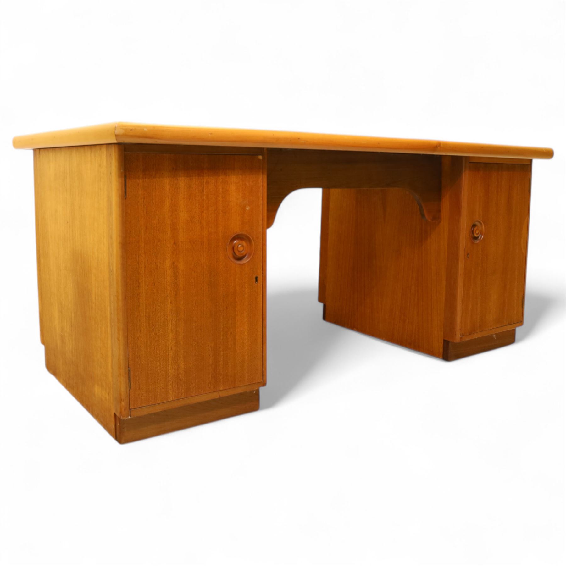 Mid 20th century teak twin pedestal partners desk, rectangular top with rounded corners with integral frieze storage shelf, above  pedestals each fitted with three drawers, recessed circular pull handles, cupboard doors fitted to the opposing side on concealed plinth bases