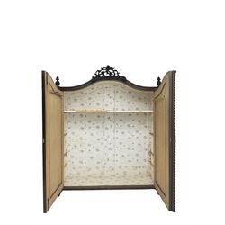 Early 20th century Italian walnut armoire wardrobe, the pierced and scrolling pediment carved with acanthus leaf detail, flanked by two scrolling cartouche with matching corbels below, the two panelled doors with applied carved rinceaux slips, with a central spiral turned upright, enclosing single shelf and hooks, raised on scroll feet