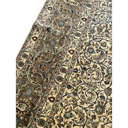 Persian Meshed carpet, ivory ground and decorated with intricate floral design with trailing scrolled branch, the central medallion decorated with stylised plant motifs, seven band border, the main band decorated with scrolls and flower head motifs