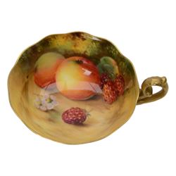 Royal Worcester fruit painted cabinet teacup and saucer, interior hand painted with apples, blackberry and cherries upon a mossy ground, the cup exterior and centre of saucer gilded, cup and saucer signed Rickells, each with puce coloured printed marks beneath, H7cm