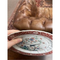 Chinese Kangxi famille verte plate, decorated with a bird perched upon a blossoming branch, within an iron red foliate border, D22cm