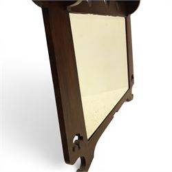 Arts and Crafts oak wall mirror, rectangular mirror plate within shaped frame, raised shelf with shaped back and pierced heart detail, bracket supports and shaped lower rail