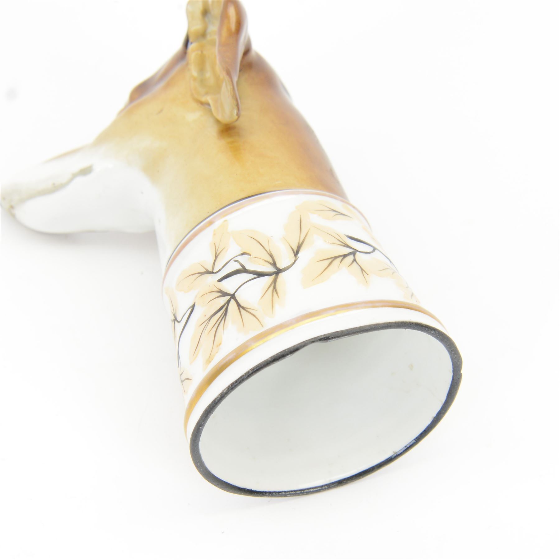 Late 19th century Continental porcelain stirrup cup, modelled as a hounds head, with wide collar detailed with lustre vines, H14.5cm