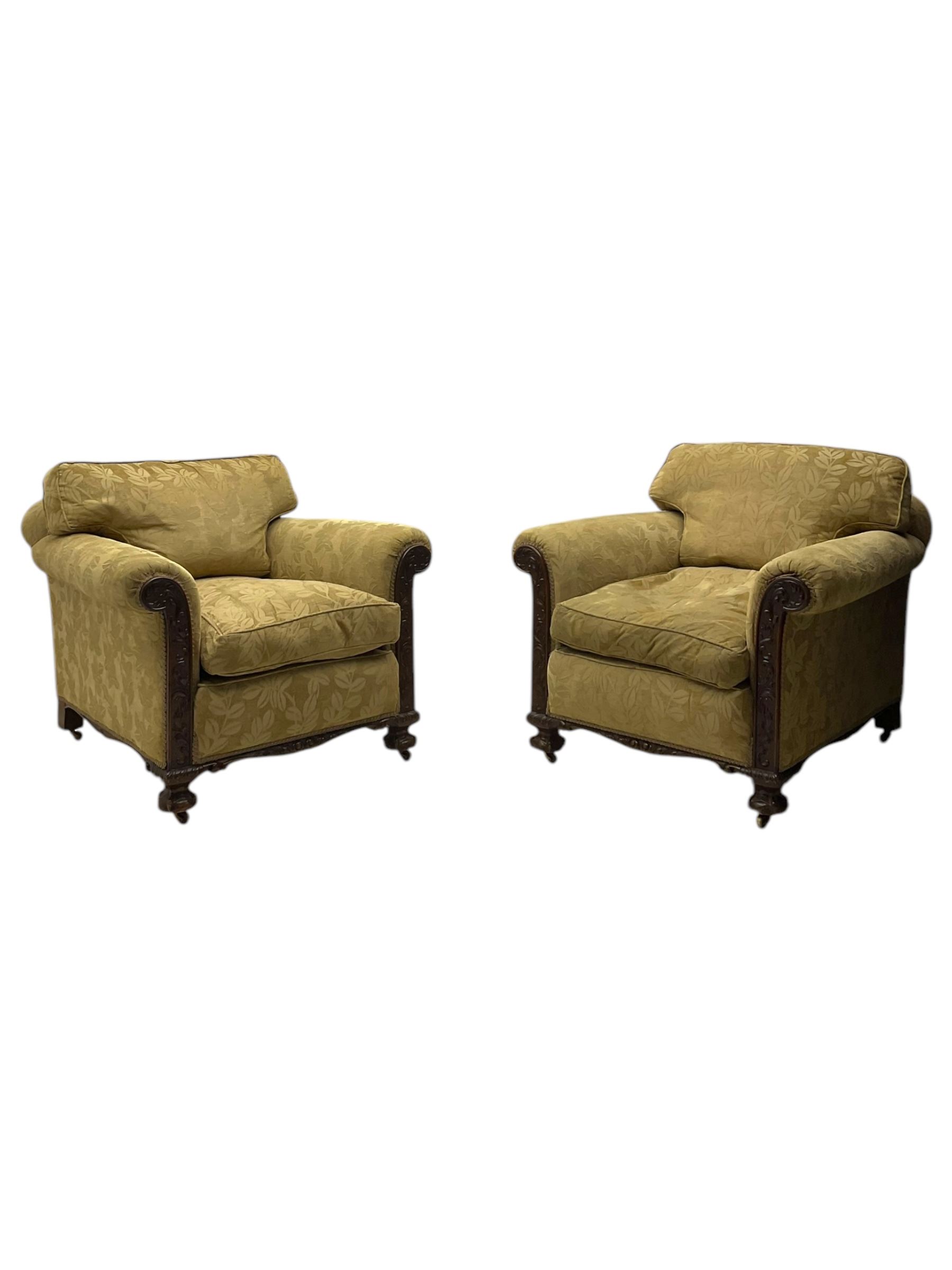 Early 20th century mahogany framed three-piece lounge suite - three-seat camelback sofa (W203cm, D105cm); pair of matching armchairs (W95cm, D96cm); upholstered in neutral foliate pattern fabric, carved with trailing leafy branches, ball and claw carved feet with brass castors 