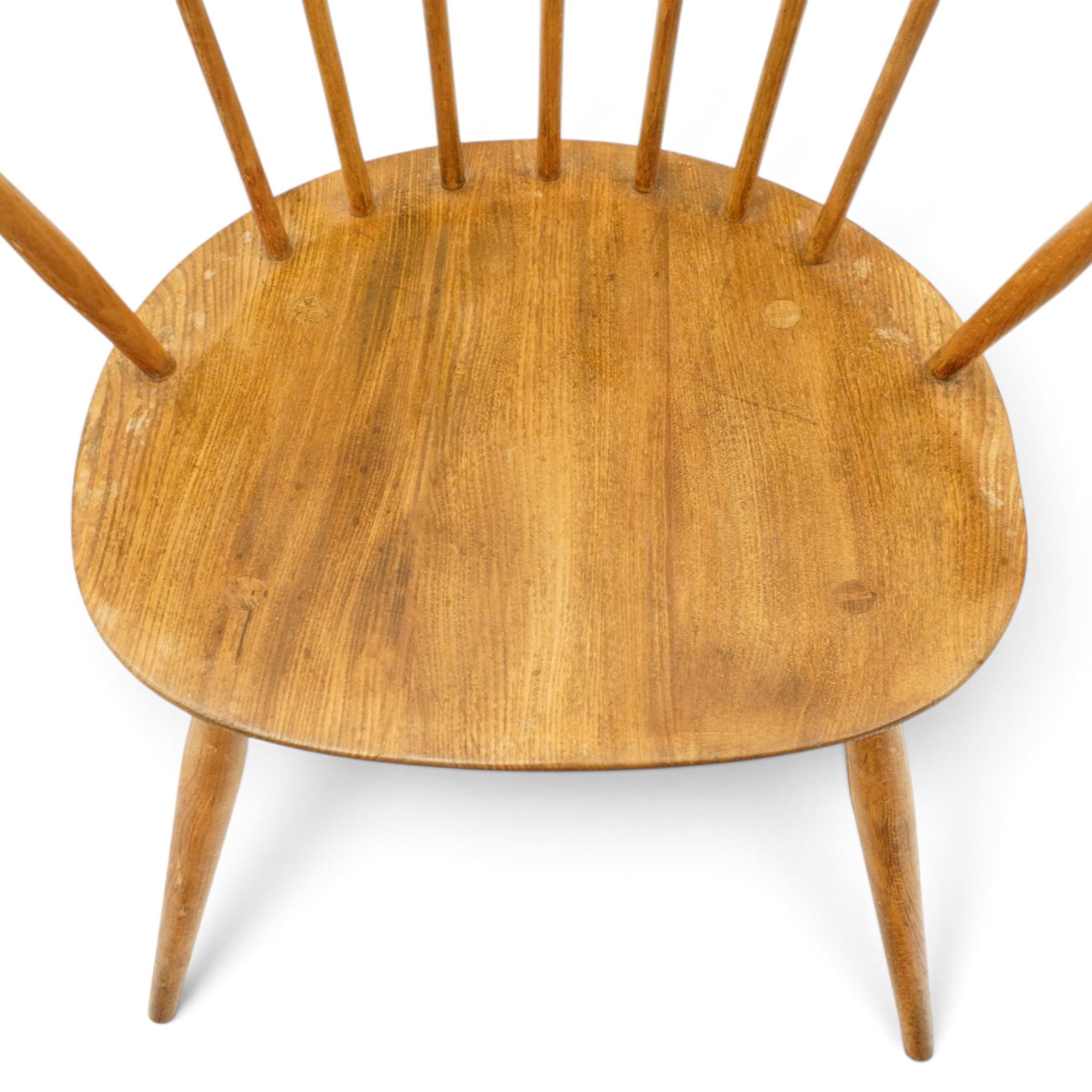 Ercol - pair of 'Cowhorn' elm carver chairs, curved back raised on nine stretchers, elm dished seats, raised on tapering supports