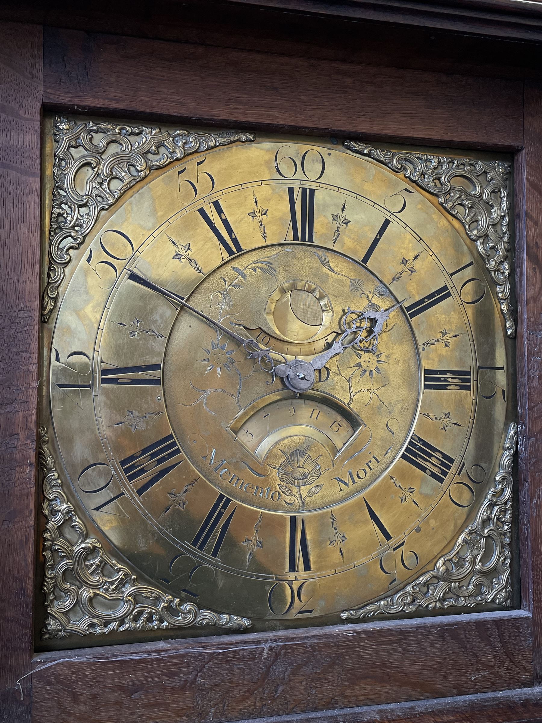 18th century c1760 oak cased George III longcase clock by William Eastwood of Burnley, with a stepped caddy top on a projecting cornice and blind frieze, square glazed door flanked by two turned pillars with gesso capitals, trunk with conforming recessed pillars and a full length wavy topped door, on a square plinth with a raised panel and shaped skirting, 12” square brass dial, 11” chapter ring with Roman numerals and five-minute Arabic's,  