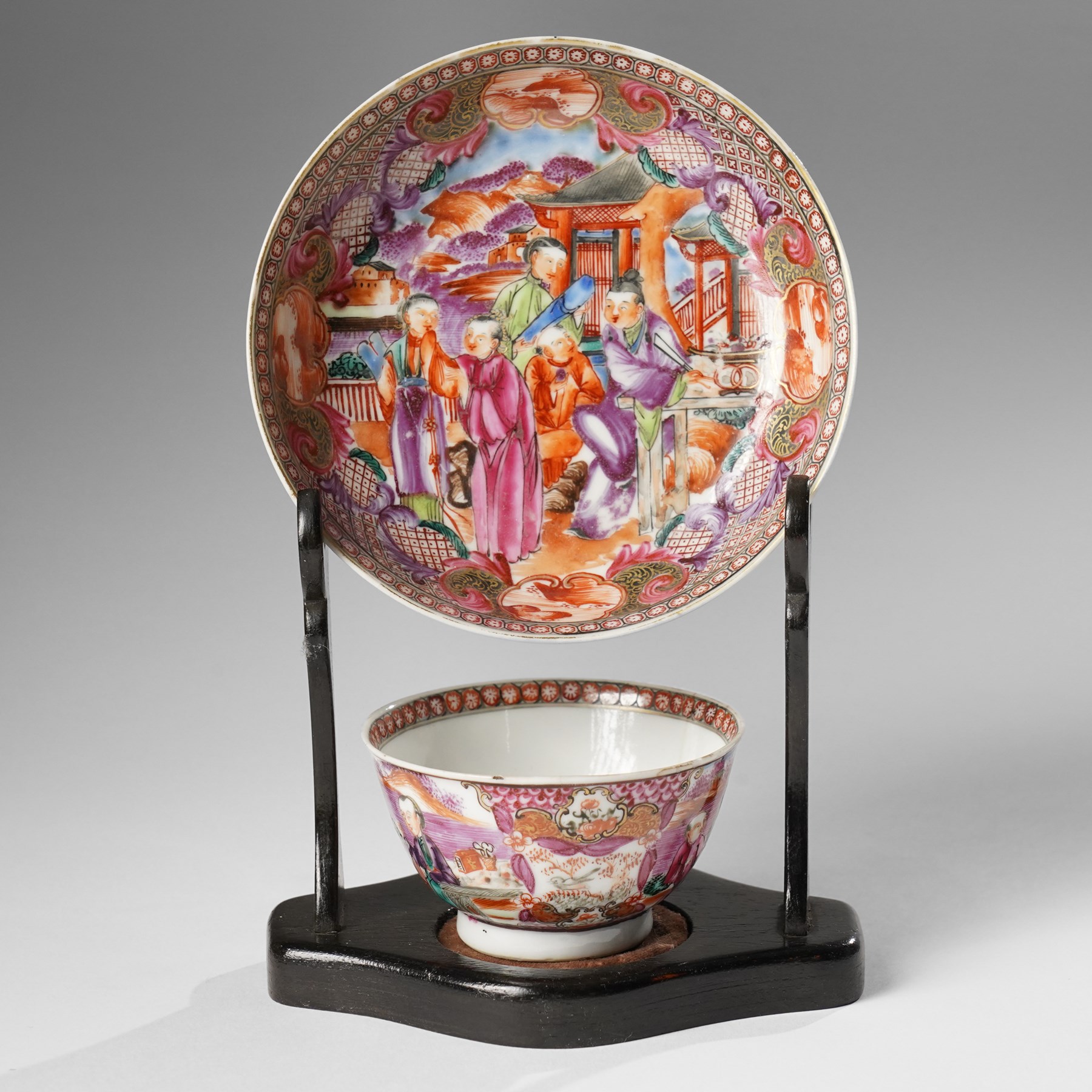 Two pairs of 18th/19th century Chinese export tea bowls and saucers, the first decorated in the 'Mandarin Palette' in typical colourways, the other famille rose examples painted with figures near a window, all unmarked (4)
