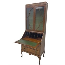 Early 20th century walnut bureau bookcase, two glazed doors over fall front, fitted with three drawers, on shell carved cabriole feet