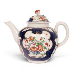18th century Worcester teapot, circa 1763-70, of globular form, painted with shaped panels of chrysanthemums and banded hedges on a blue scale ground, cover with flower finial, mark beneath, H15cm