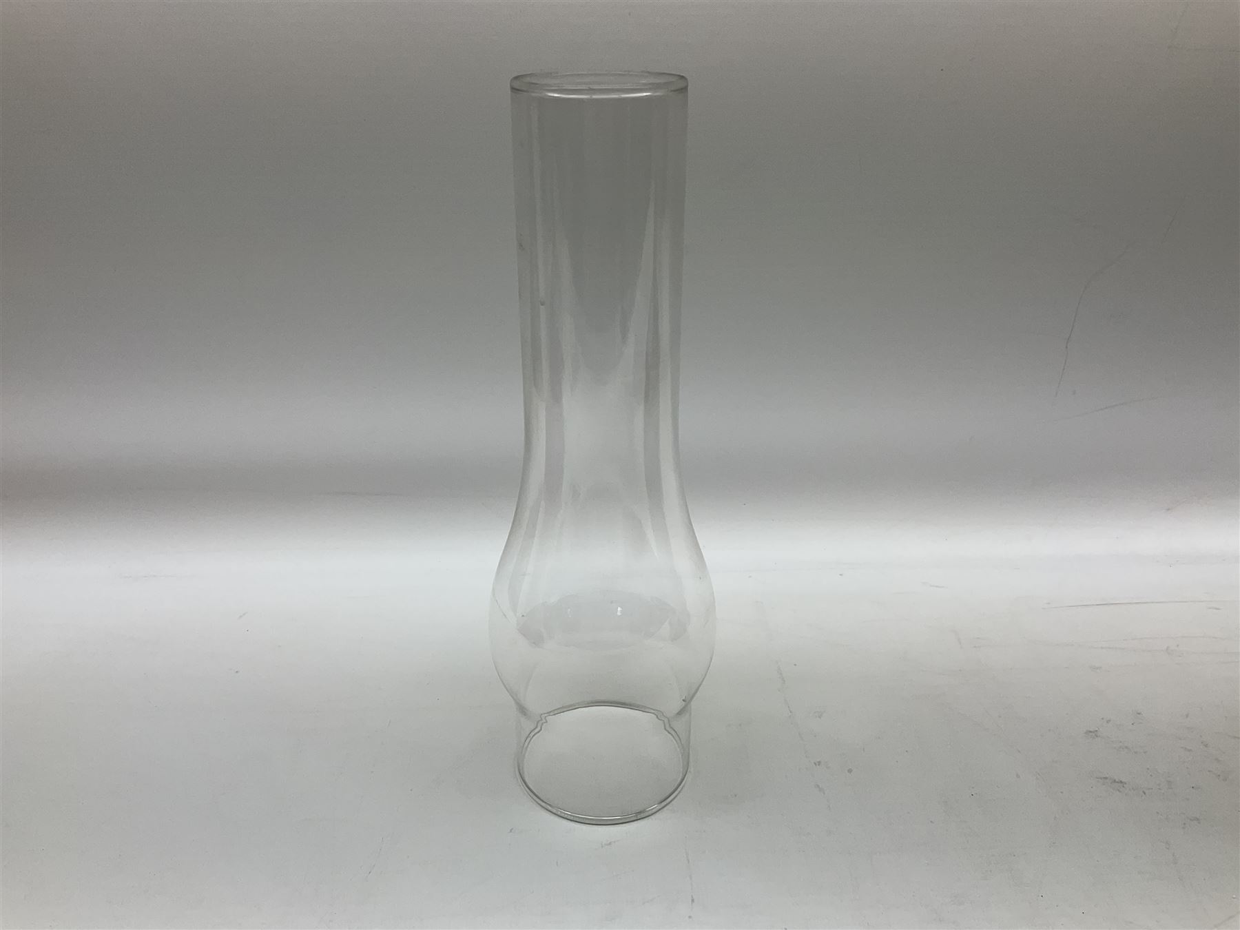 Victorian table oil lamp with black glazed stepped circular base, reeded brass column, moulded pink glass reservoir, duplex burner and frilled rim frosted glass shade with clear glass chimney H69cm