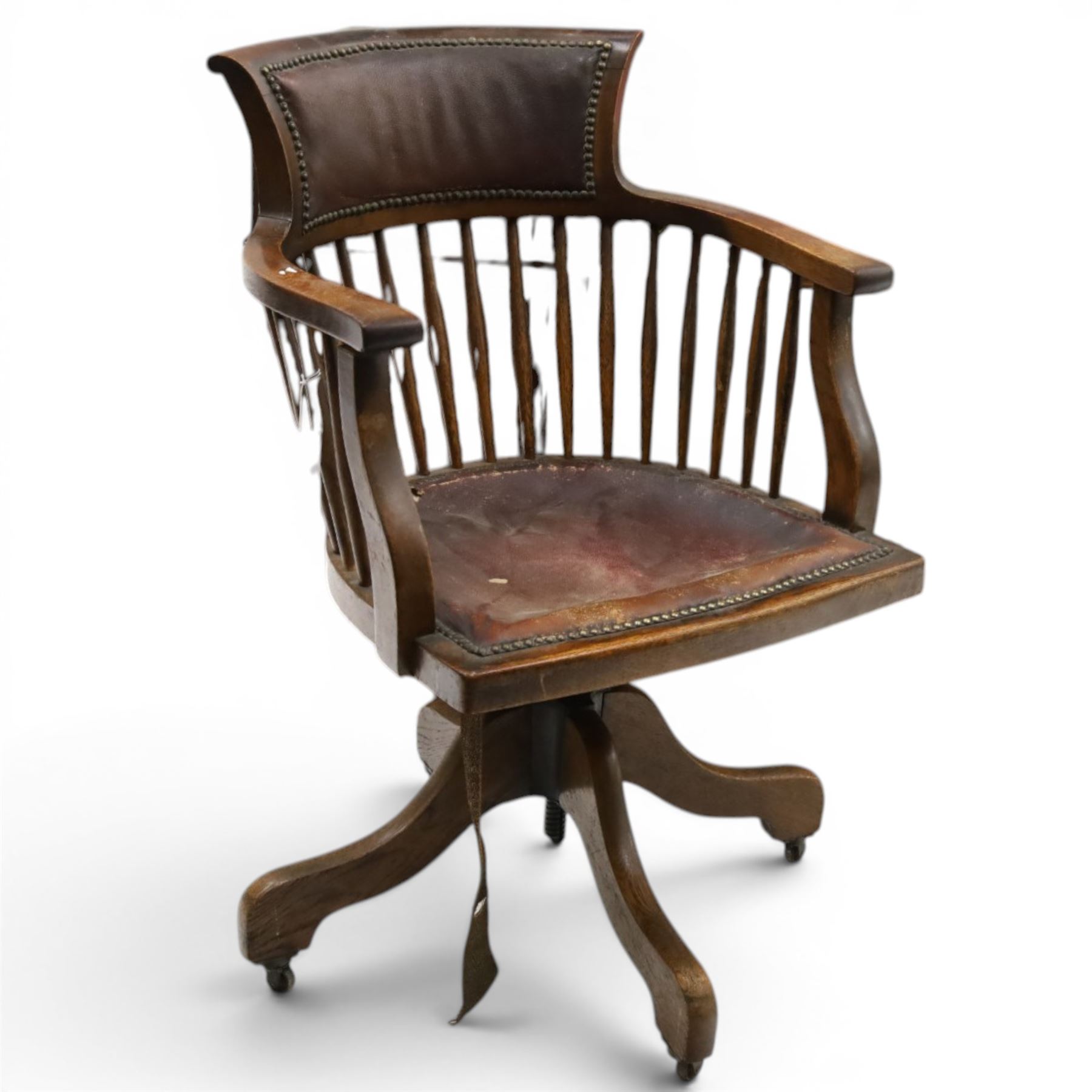 Late 19th century twin-pedestal desk, red leather inset top over an assortment of eleven drawers, on plinth base (W126cm D65cm H77cm); with Edwardian oak framed Captains swivel desk chair, of tub shaped form with spindle back supports (W60cm H89cm)