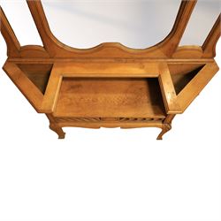 Art Nouveau oak hall mirror, the scrolling frame with large central bevelled mirror plate, boardered by six small mirrors with four shelves between, the base, with carved and pierced floral decoration, upon six cabriole legs   