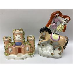 Collection of 19th century and later Staffordshire figures, to include a mid 19th century figure group of circus performers upon horseback, figure of a young girl in floral dress with her arm around a black spotted rabbit, other figure groups and quantity of houses, castle and clock tower figure, tallest H22cm (13)