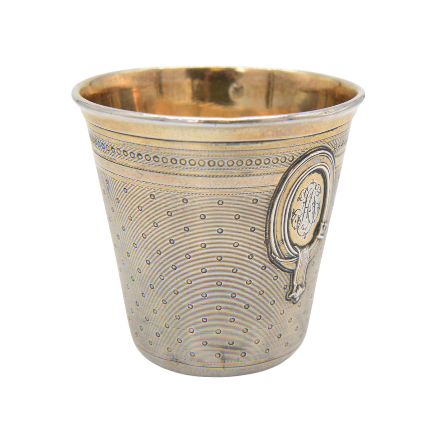 Early 20th century French silver wine tasting beaker, slightly tapered form with gilt interior, the body decorated with engraved monogram and engine turned pattern with makers mark for Emile Puiforcat, H6cm