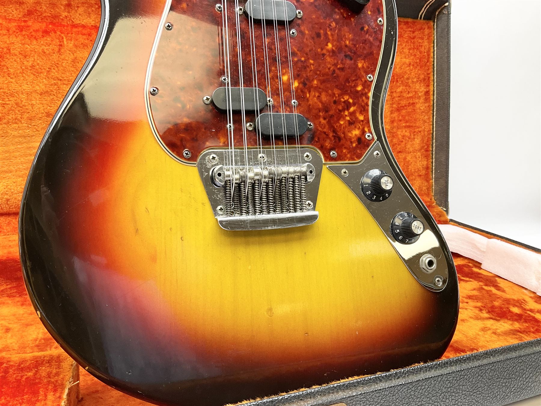 Fender three-tone Sunburst 12-string electric guitar c1965/6 Fullerton USA, with alder body and maple neck, the Indian rosewood fretboard with twenty-one frets and pearloid dot markers, fender electric XII bridge, F-stamp tuners (non-original), two split single coil pick-ups, master volume and tone and four-way switch, serial no.129730, L108cm; in original Fender case bearing label for Rivington Guitars New York with copy of original invoice; together with GuitarKes set-up and service certificate dated October 2021
