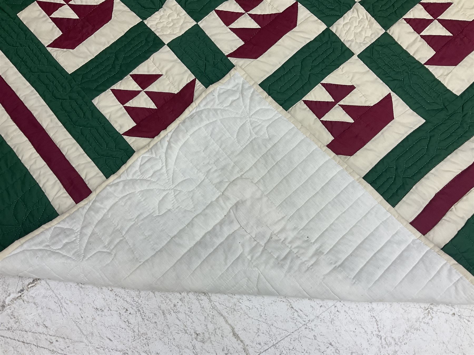 20th century quilt, with repetitive ship design to the centre within a cream red and green boarder, 227cm x 222cm