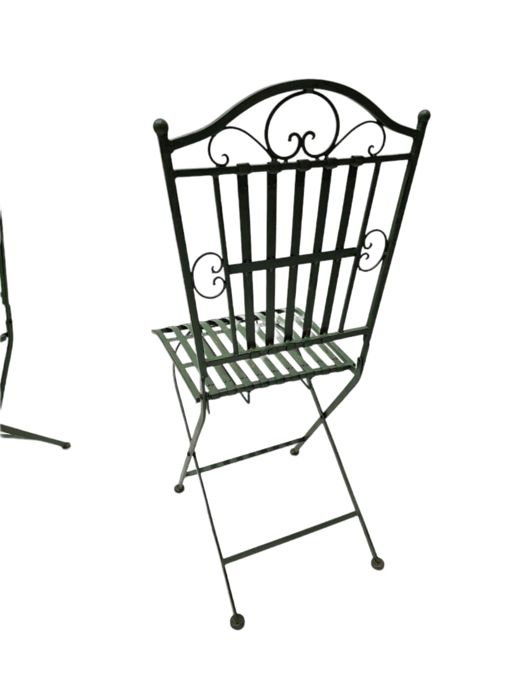 Wrought metal slatted round folding garden table and four chairs in green finish - THIS LOT IS TO BE COLLECTED BY APPOINTMENT FROM DUGGLEBY STORAGE, GREAT HILL, EASTFIELD, SCARBOROUGH, YO11 3TX