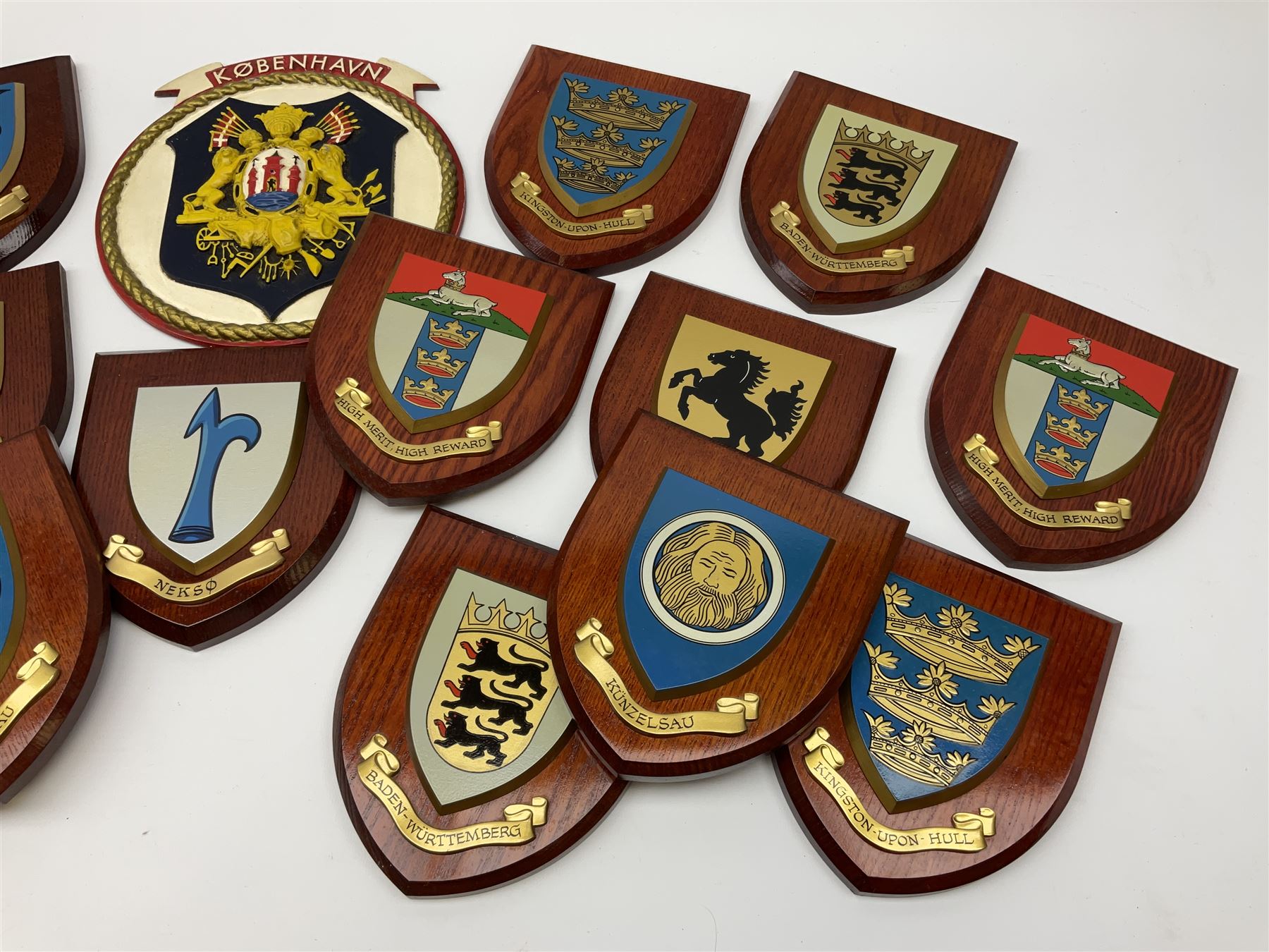 Various European cities and states, wooden heraldic shields each with hand painted raised shield including Baden Wurttemberg, Kunzelsau, City of London, Kingston upon hull etc, seventeen in total. . 