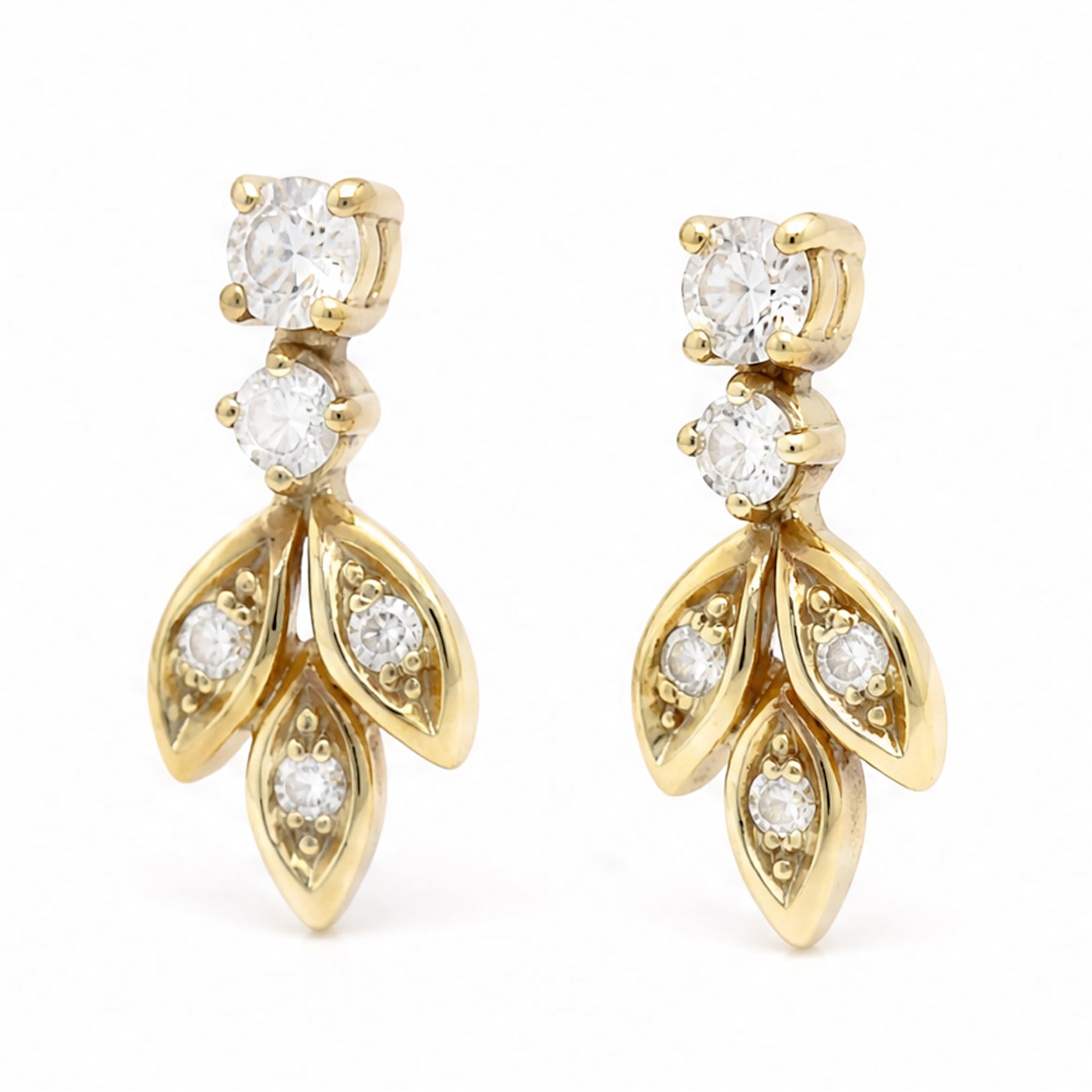 Pair of 18ct gold diamond leaf design earrings, each stud with diamond set leaves, suspending from two round brilliant cut diamonds, Sheffield import mark 1989, total diamond weight approx 0.40 carat