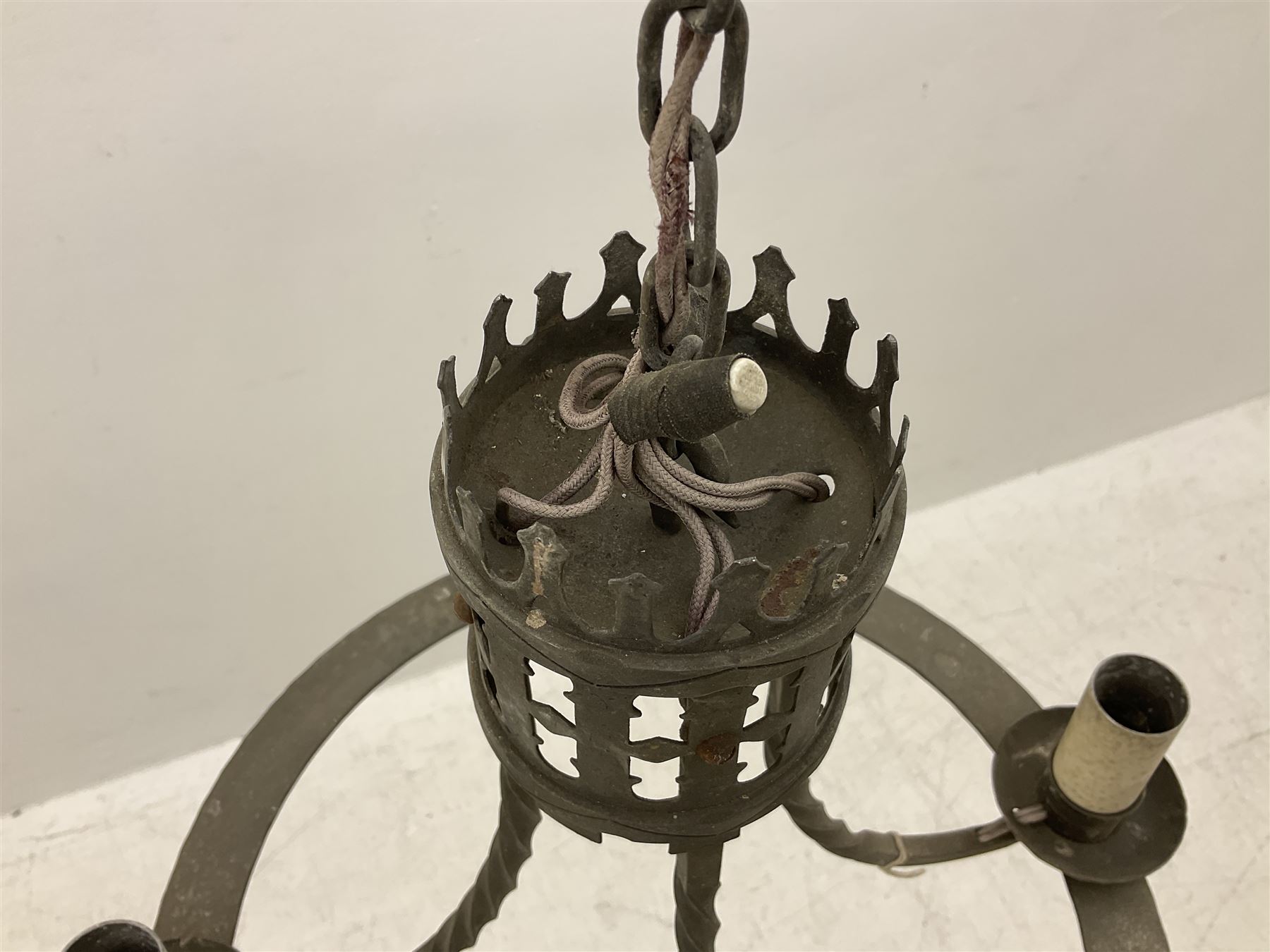 Gothic style iron chandelier with drip pans and twisted branches together with three matching twin wall sconces